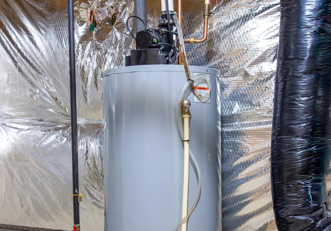 A small water heating unit in a home utility closet